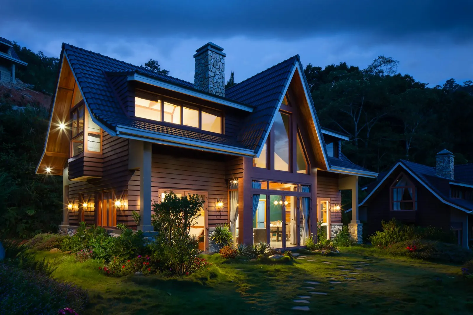American home glowing at dusk with warm interior lights
