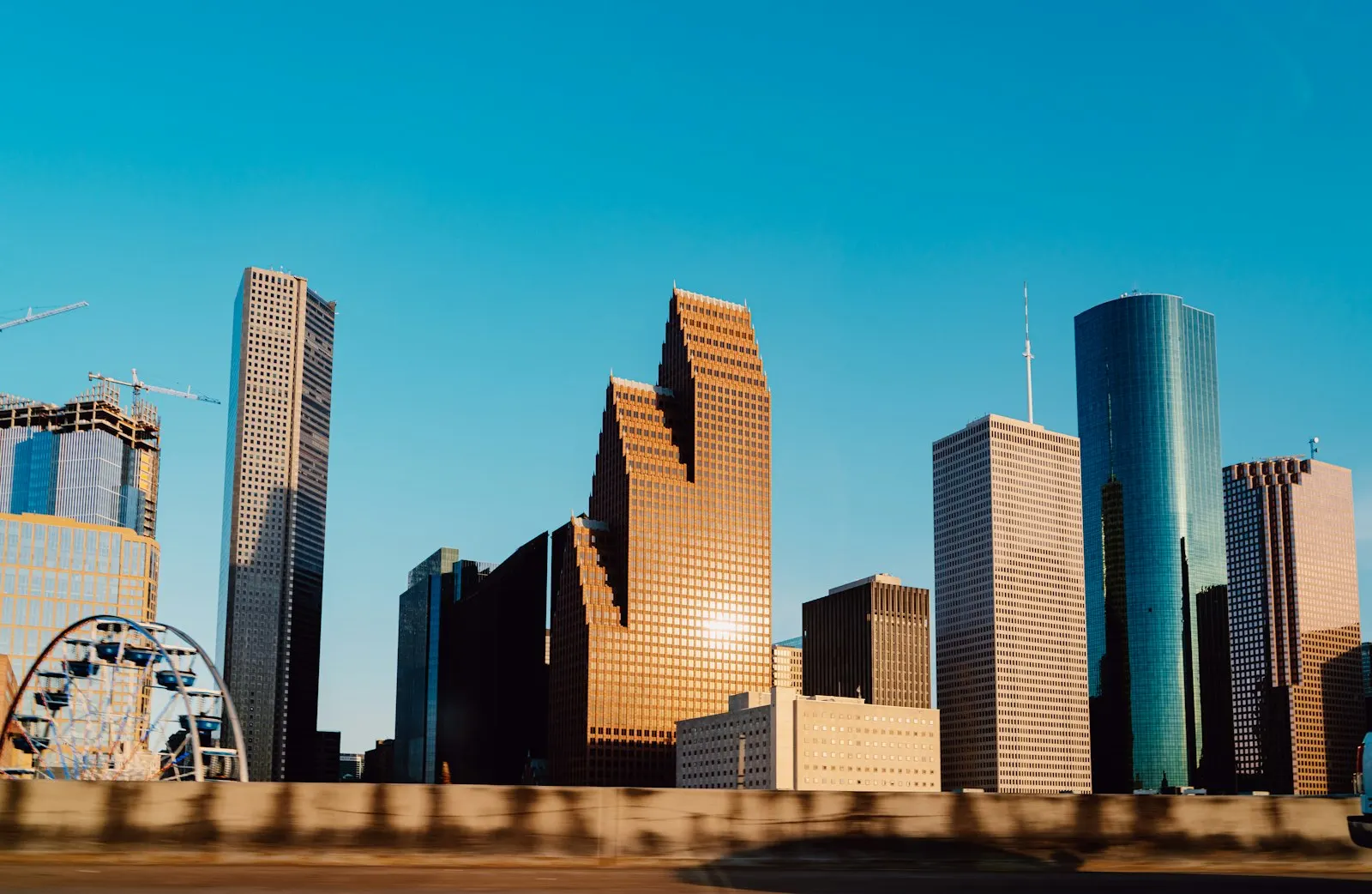 Houston downtown skyline towers against a clear blue sky