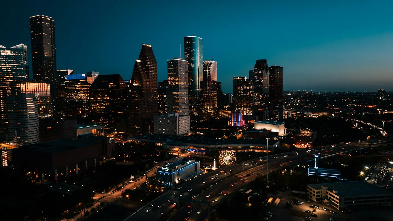 Houston skyline glowing at dusk above the city highways
